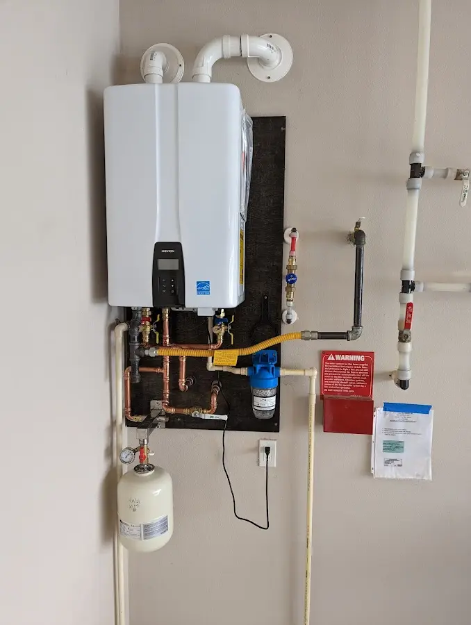 Professional plumber installing copper piping in a Park City home